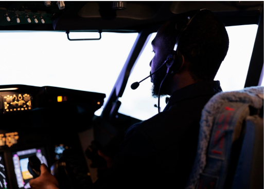 African student pilot standing near an aircraft