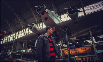 Man exploring an aviation museum with historic aircraft