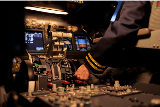 Female pilot operating cockpit controls before takeoff